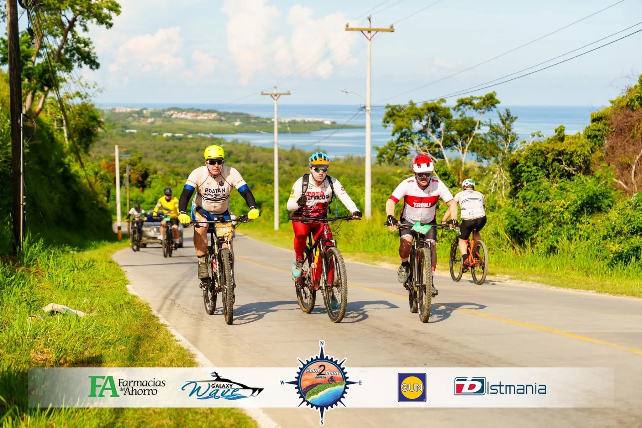 Roatán Point 2 Point — peloton ciclismo carretera vista mar roatan.